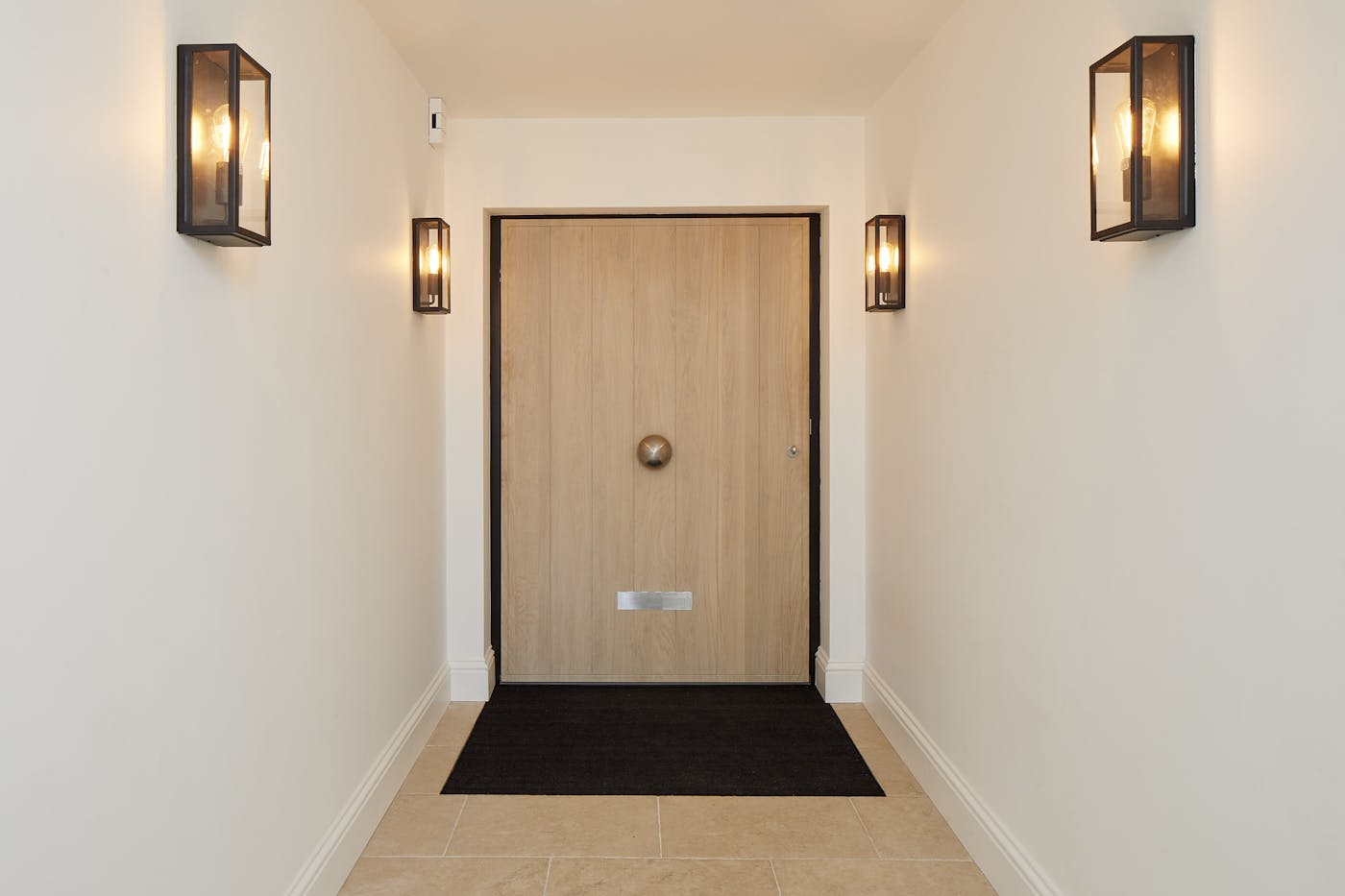 Inside, the door is lifted by a white oil wash, working with the tiled floors and light paintwork