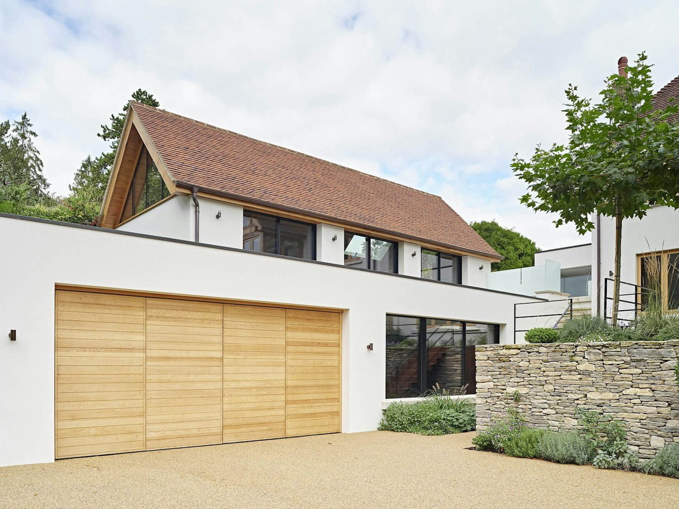 Across the drive, our Parma double bi-fold garage doors stand at 5400mm wide