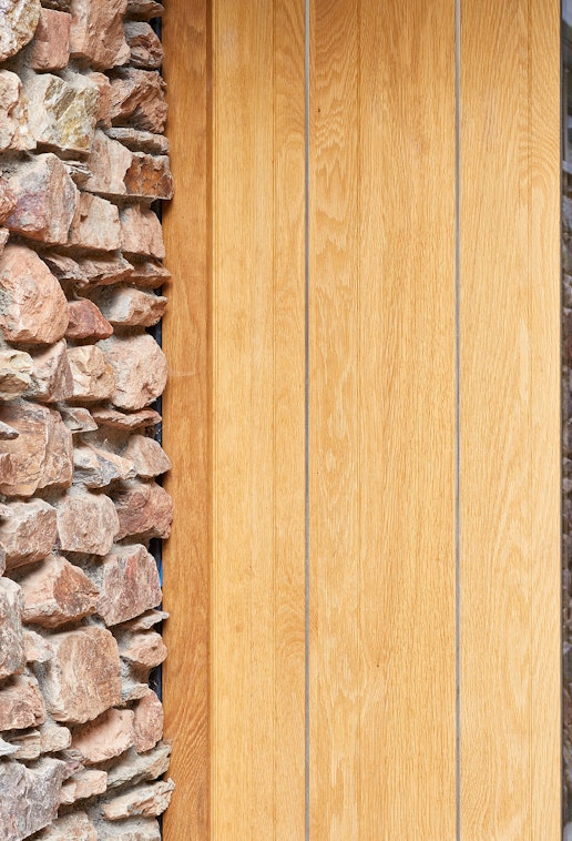 Stainless steel strips expertly contrast with the european oak and exterior stonework