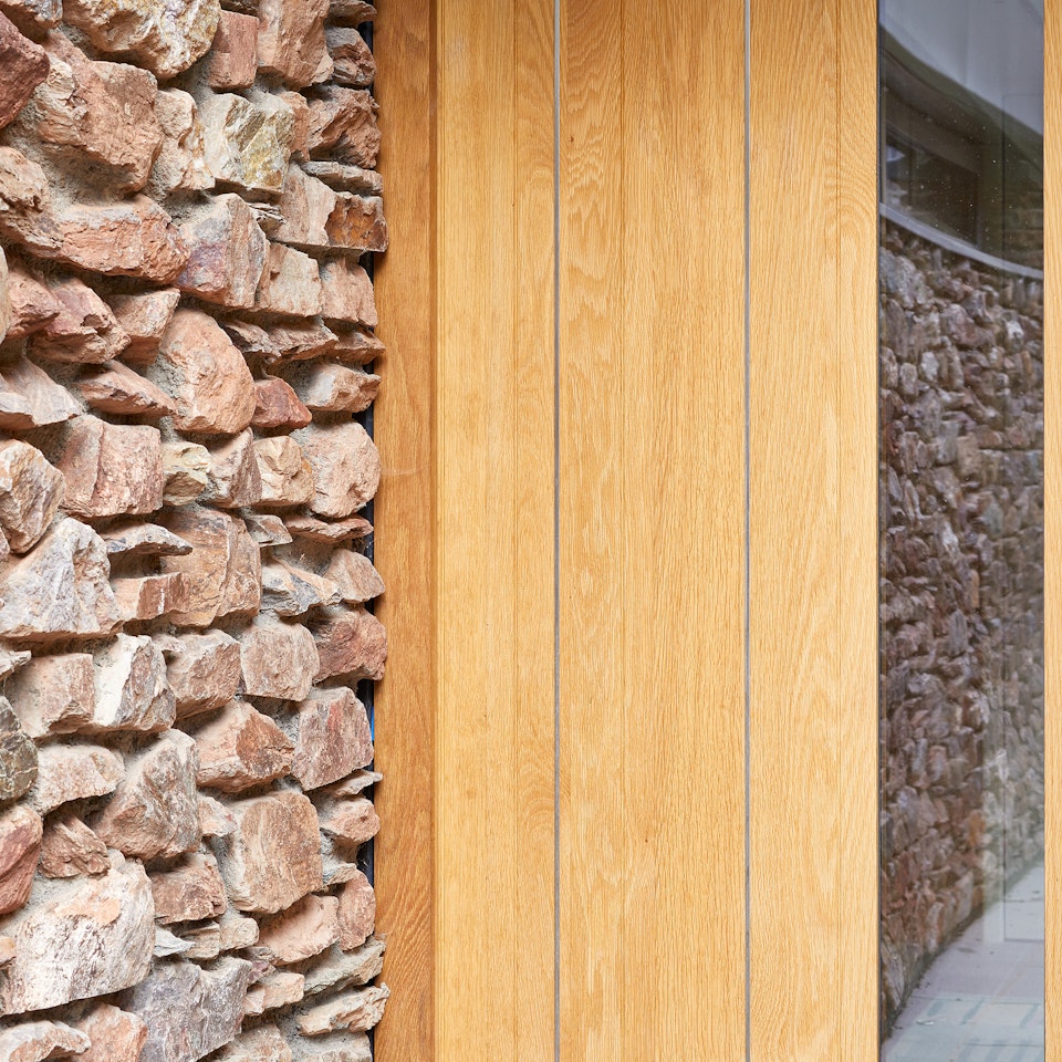 Stainless steel strips expertly contrast with the european oak and exterior stonework