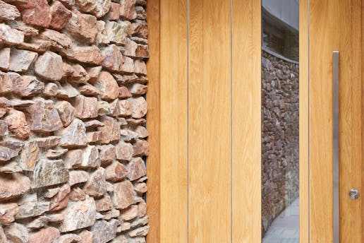 Stainless steel strips expertly contrast with the european oak and exterior stonework
