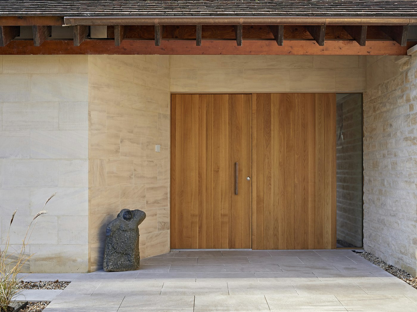 The front entrance has our flush Porto design combined with matching wood flush side panel that extends the appearance of the entrance to double the width