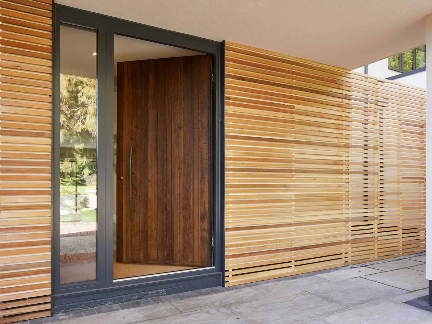 Our Rondo V fumed oak front door has a hinged opening in this house