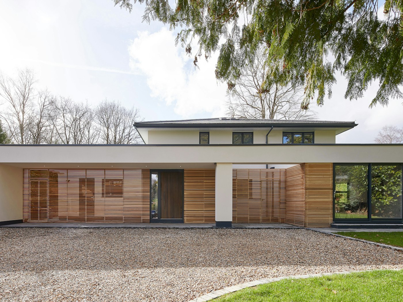 A wonderful example of modern architecture with a fumed oak wood front door