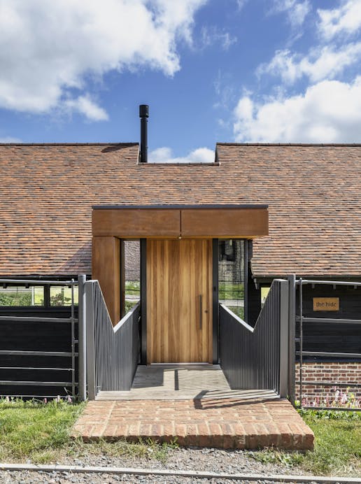 Urban Front's Rondo V front door in iroko sets off the entrance to this incredible modern rebuild
