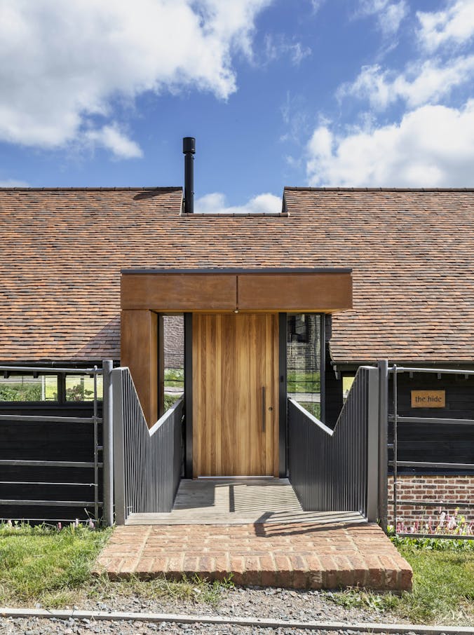 Urban Front's Rondo V front door in iroko sets off the entrance to this incredible modern rebuild