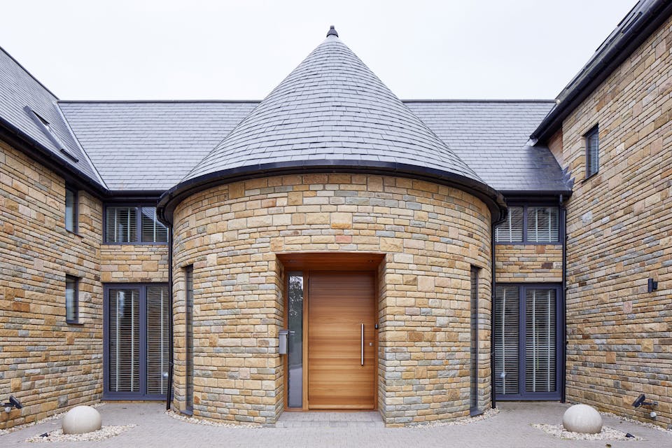 Parma doorset in iroko with one glass side panel in sandblasted finish