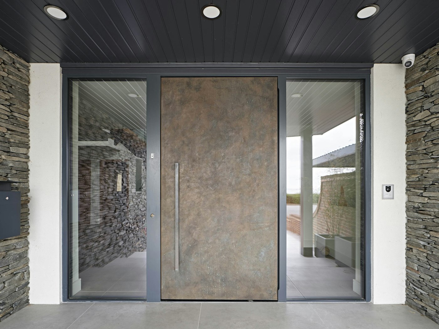 Urban Front's oversized bronze metallic front door makes an imposing statement