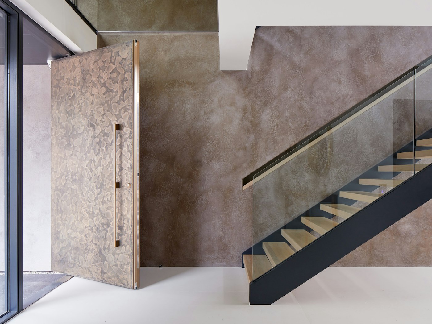 Bronze door open, interior staircase | Urban Front