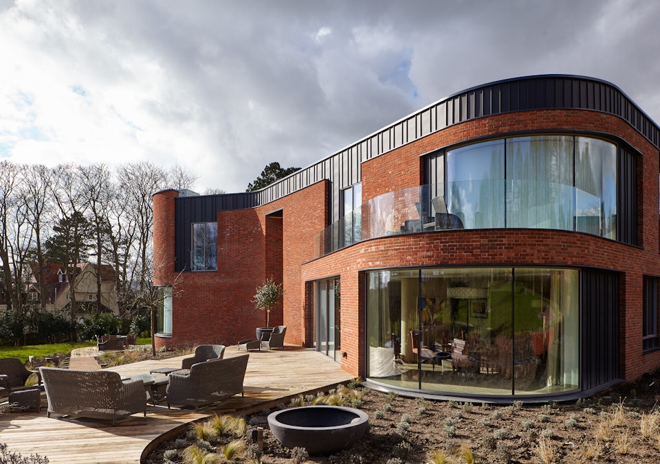 The curved passive house design features 5 Urban Front external doors 