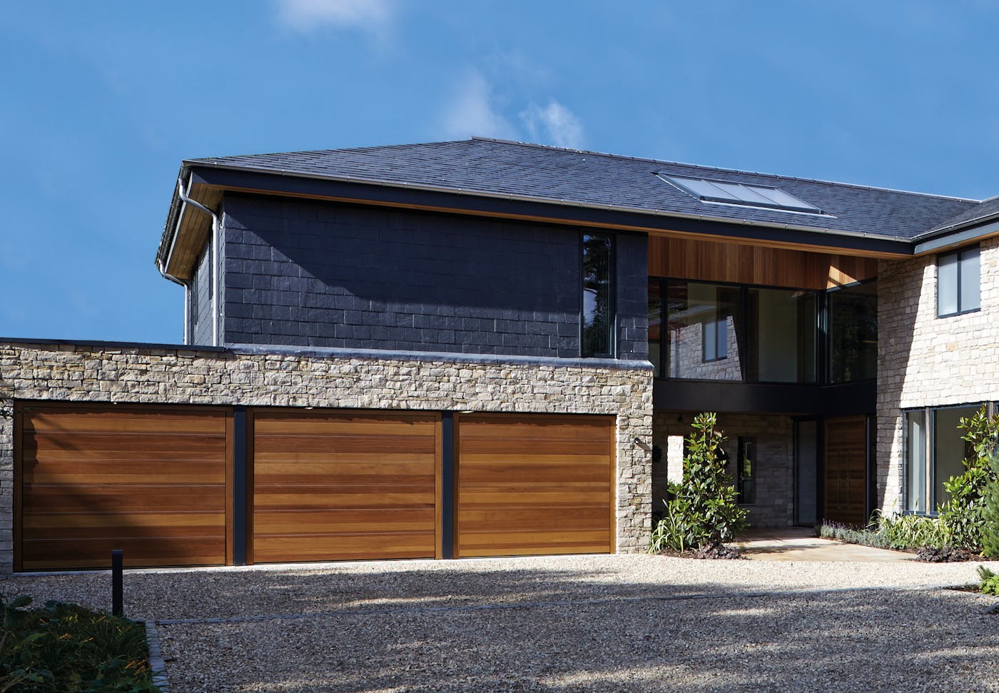 triple up and over garage in iroko with stainless steel inserts