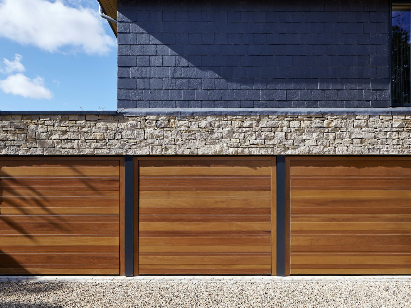 triple garage in iroko with stainless steel inserts