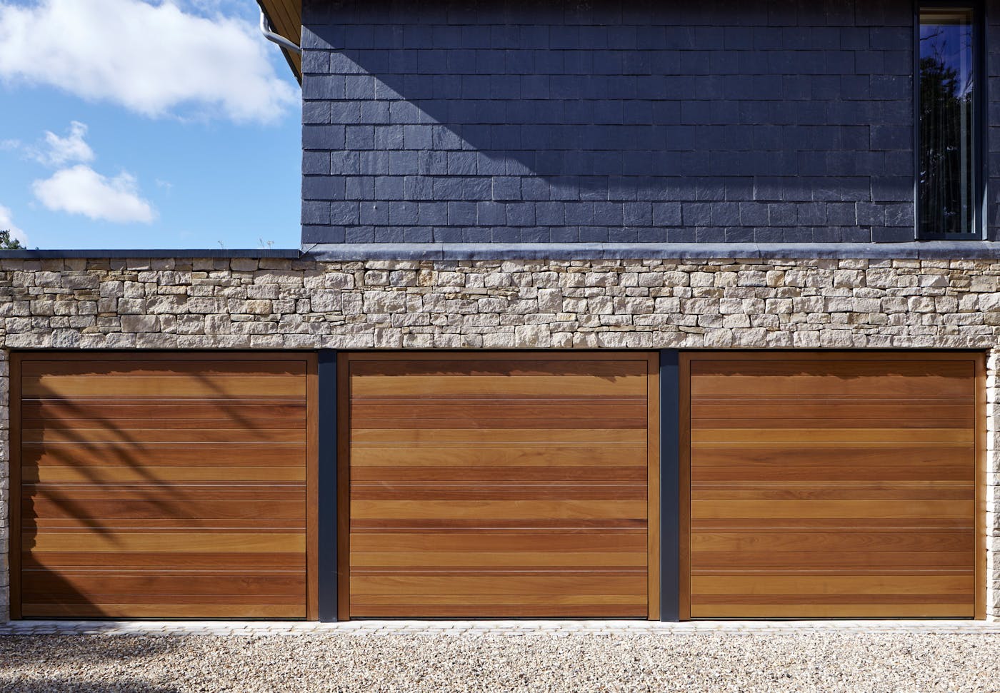 triple garage in iroko with stainless steel inserts