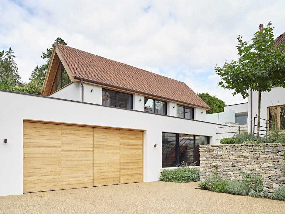 Our Parma design, double bifold garage door in European oak, measuring 5400mm W x 2400mm H