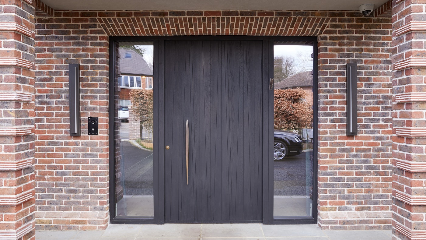 European oak timber front door, finished with ebony oil and an elegant bronze handle