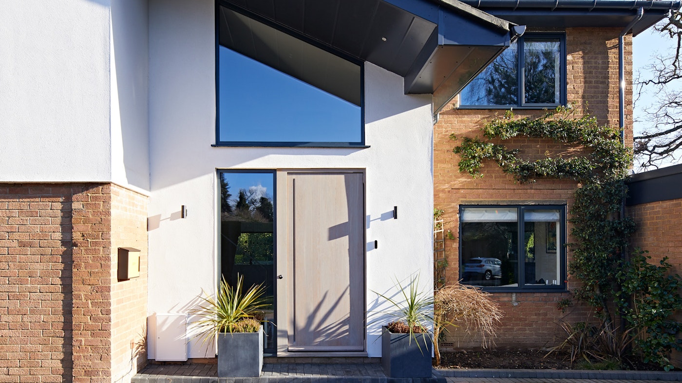 This house got a grade A makeover and a beautiful European oak, grey-oiled front door to complement grey windows. 