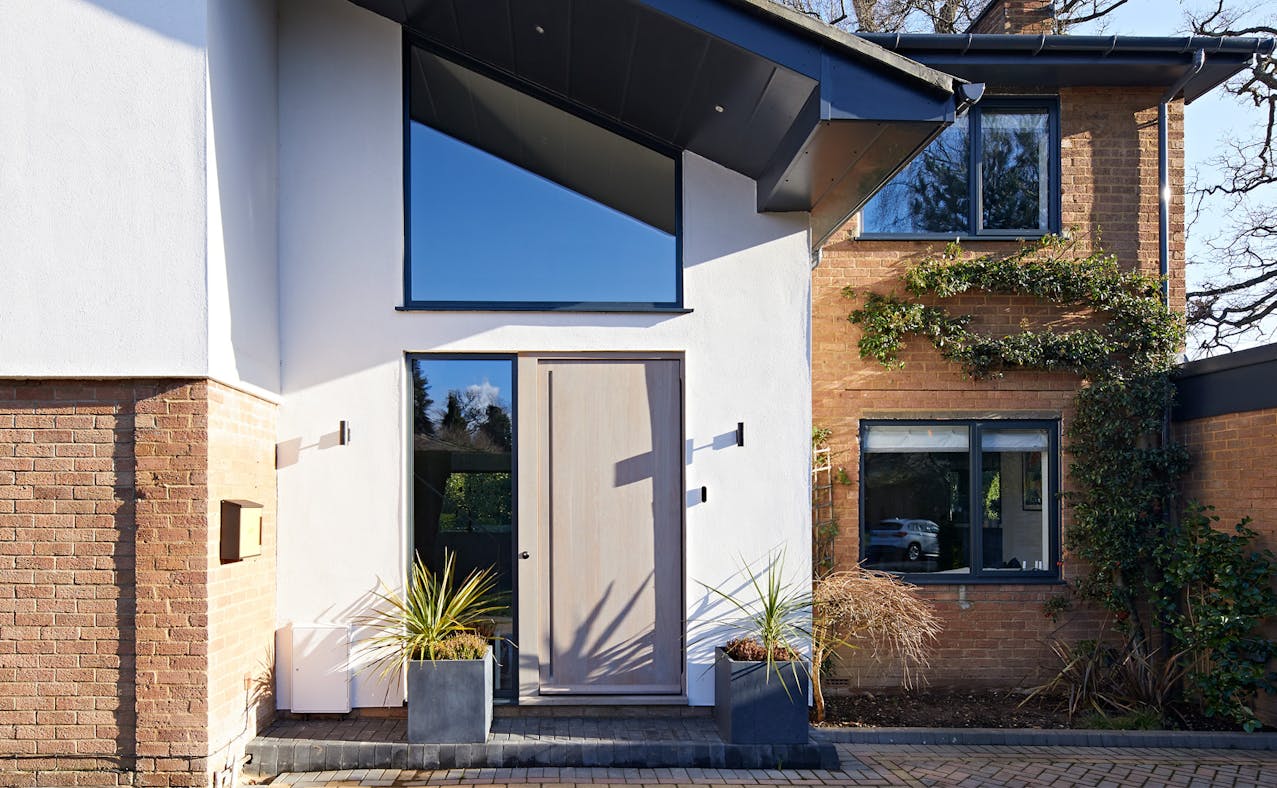This house got a grade A makeover and a beautiful European oak, grey-oiled front door to complement grey windows.