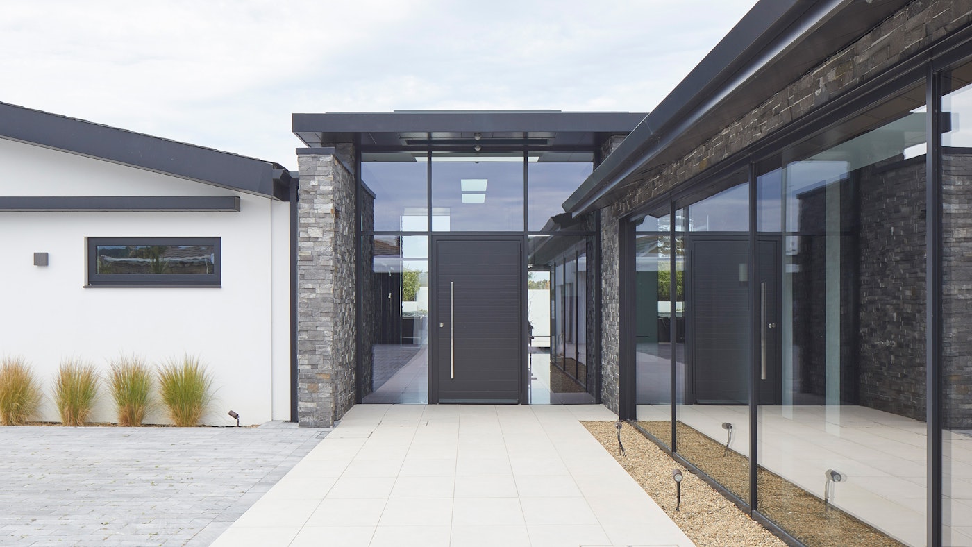 A very modern build with a pure black RAL-painted front door