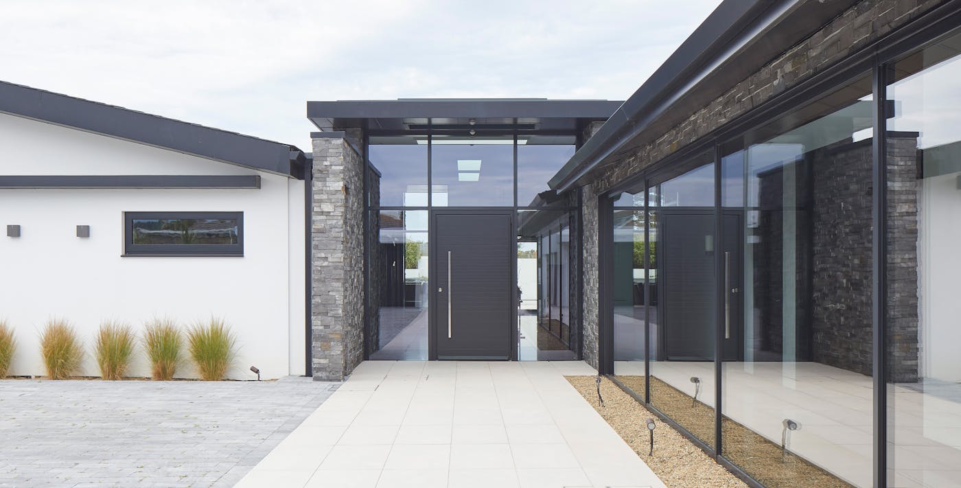 A very modern build with a pure black RAL-painted front door