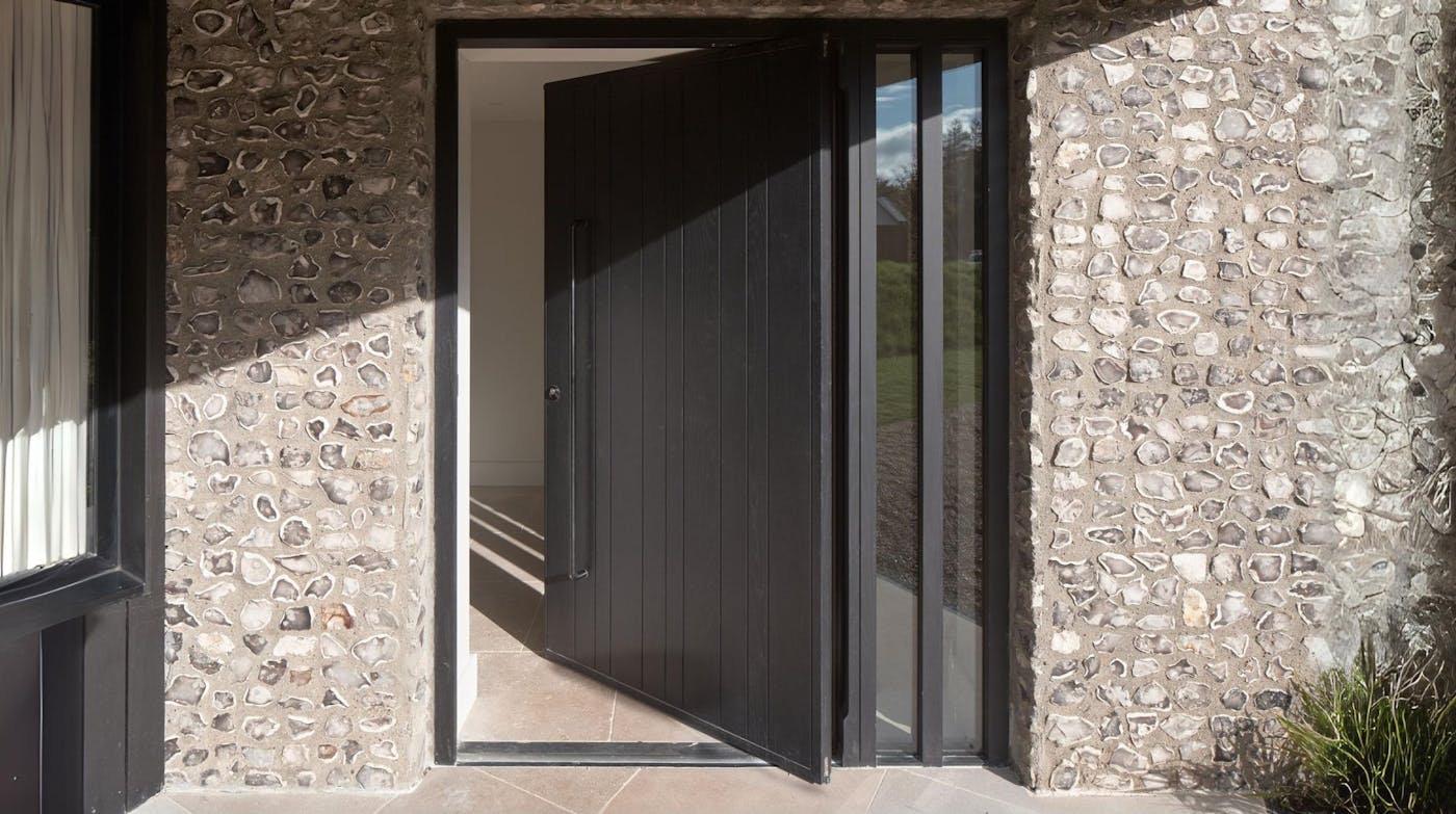 Pivot door in oak, finished with ebony oil and ridge sidelites