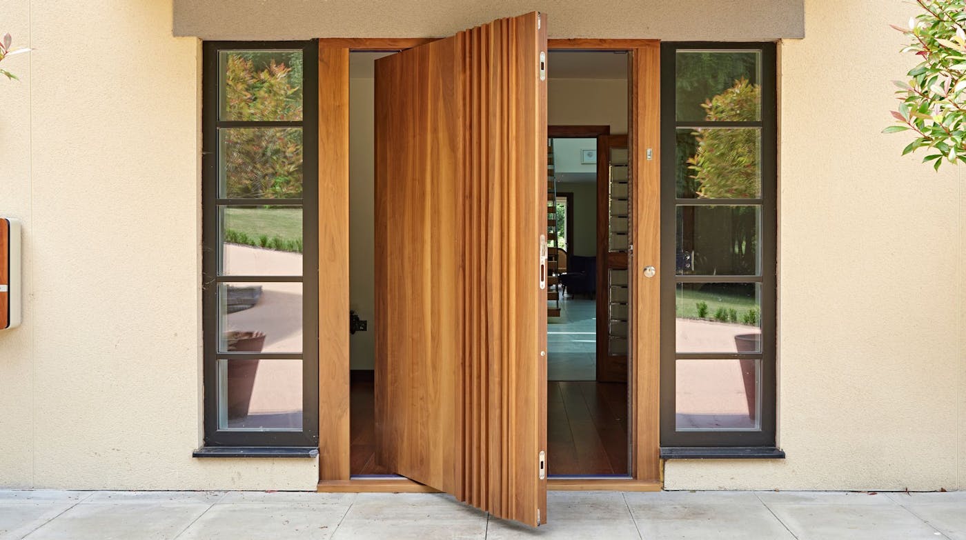 Bari pivot door in American Black walnut
