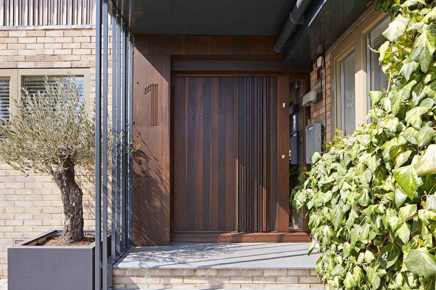Our exquisite "Bari" design shown here in fumed oak & with canopy protection. This door has a pivot opening and measures 1500mm W x 2000mm H