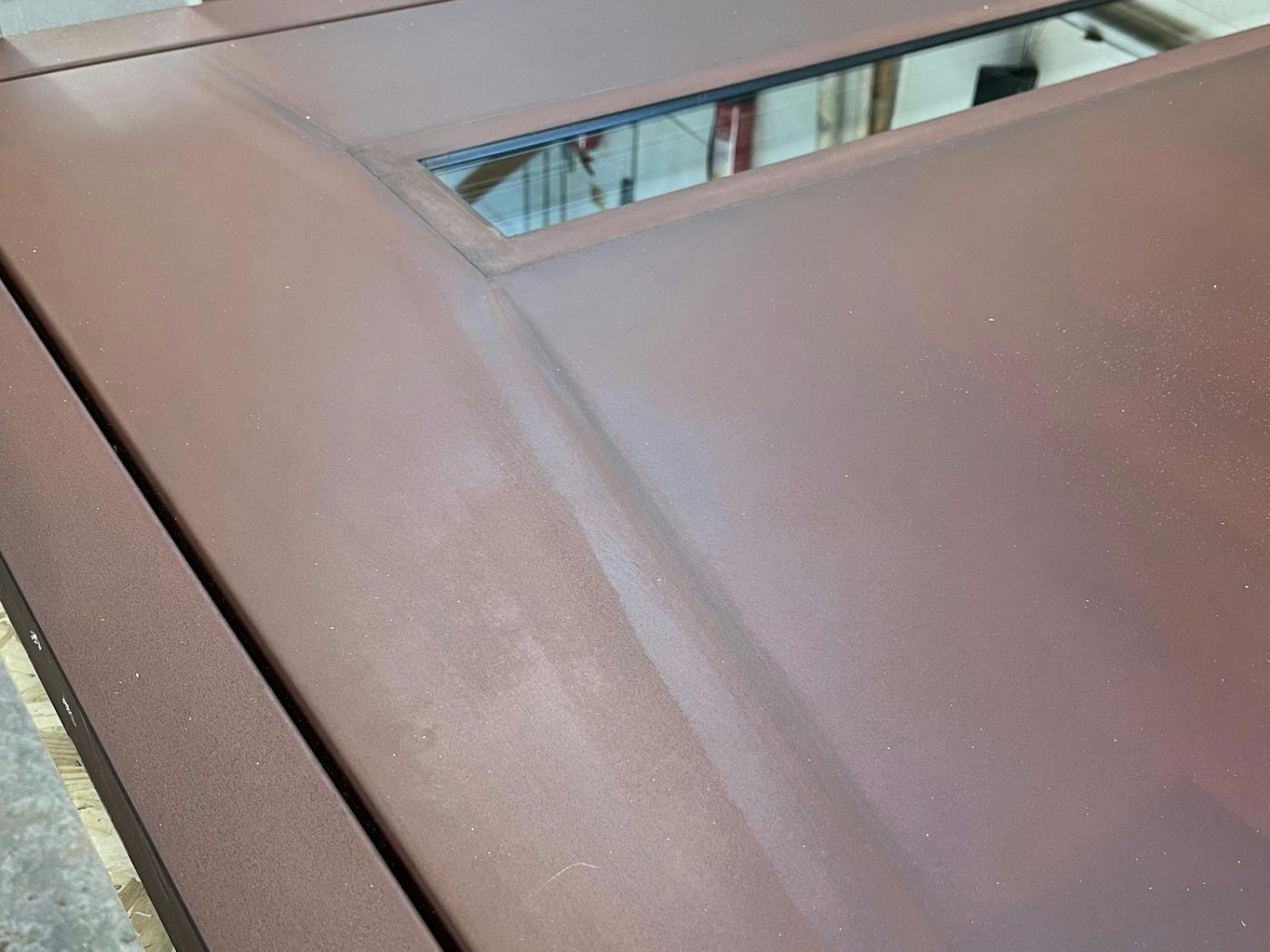 A steel door in the Urban Front workshop showing colour variations