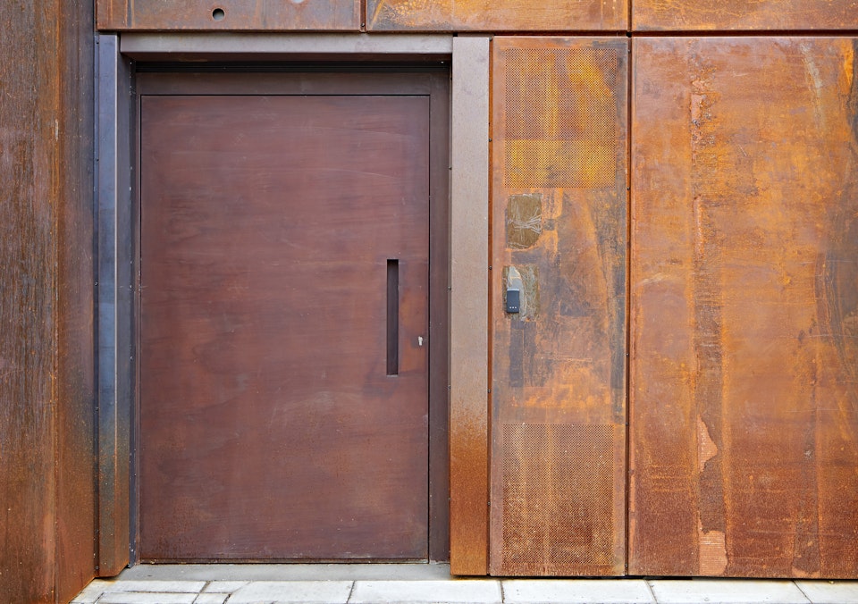 "Raw" steel door in a rust (corten) finish on a commercial building in London