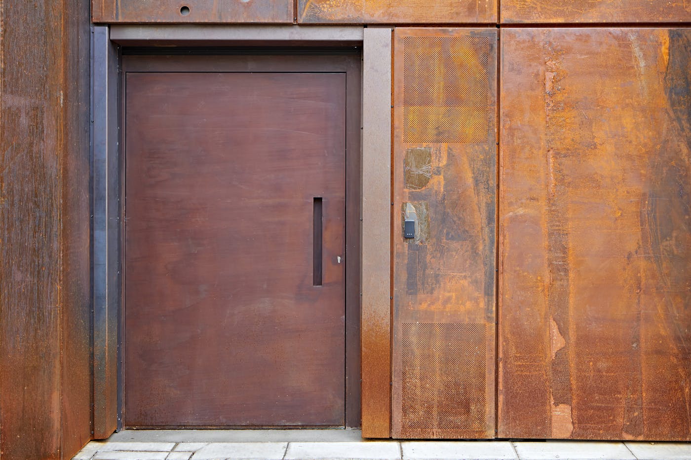 "Raw" steel door in a rust (corten) finish on a commercial building in London