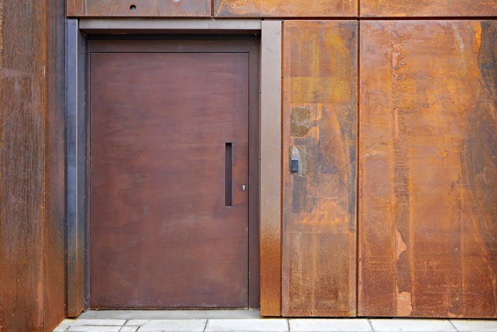 "Raw" steel door in a rust (corten) finish on a commercial building in London