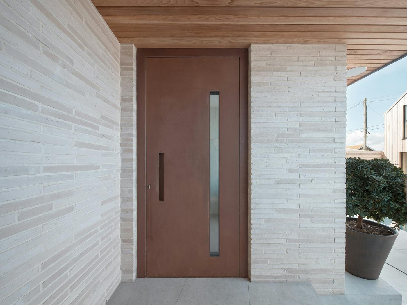 Steel door with a contemporary rust finish and concealed handle
