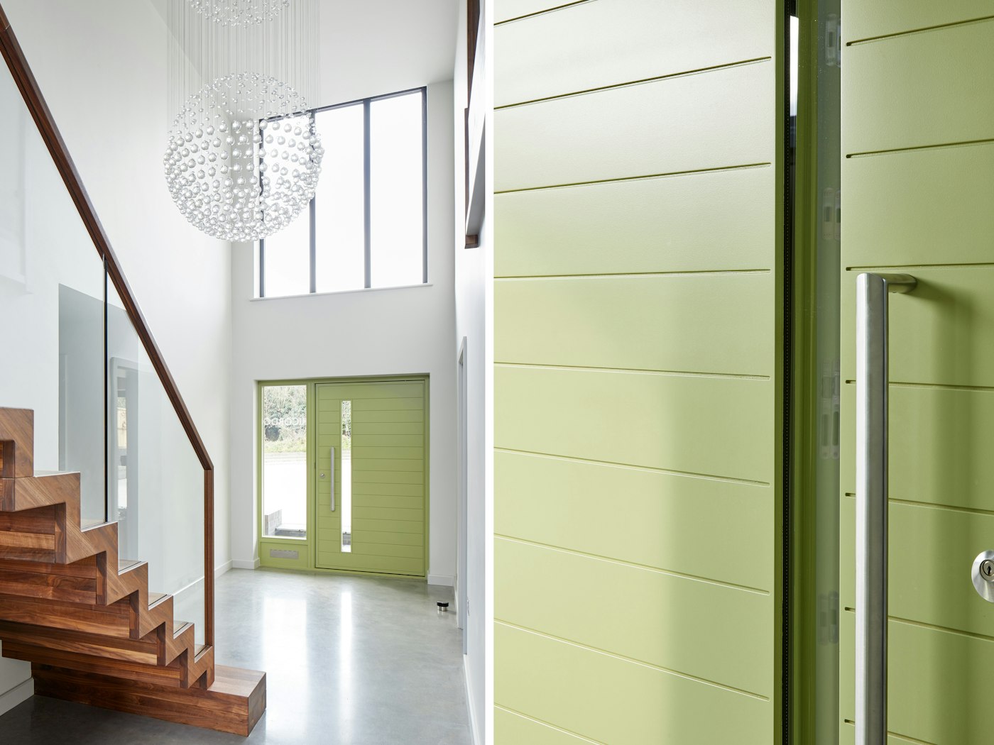 The clean white interior is the perfect base to show off the bold green door and rich walnut staircase