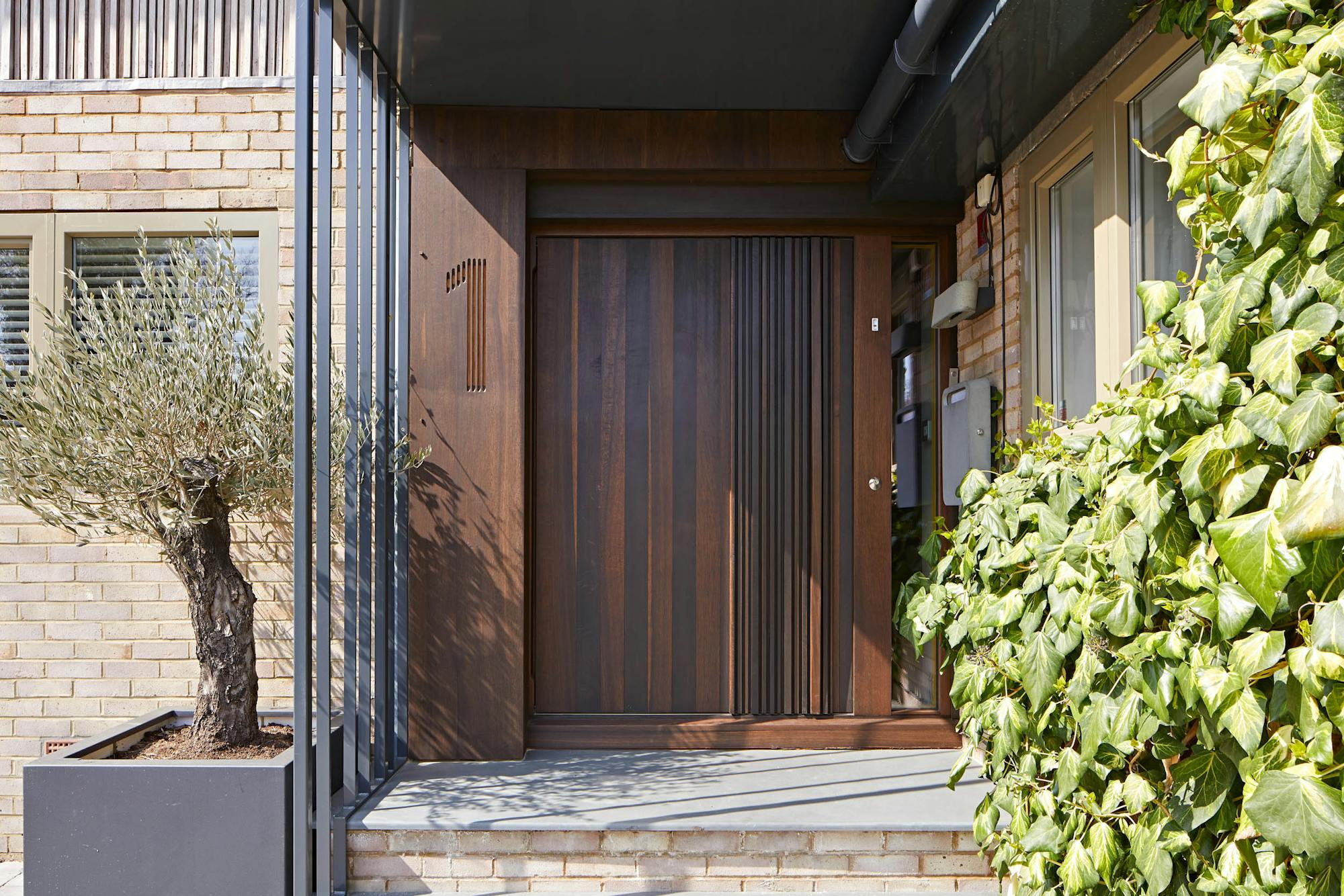 Bari door design in fumed oak, integrated wooden handle and number etching